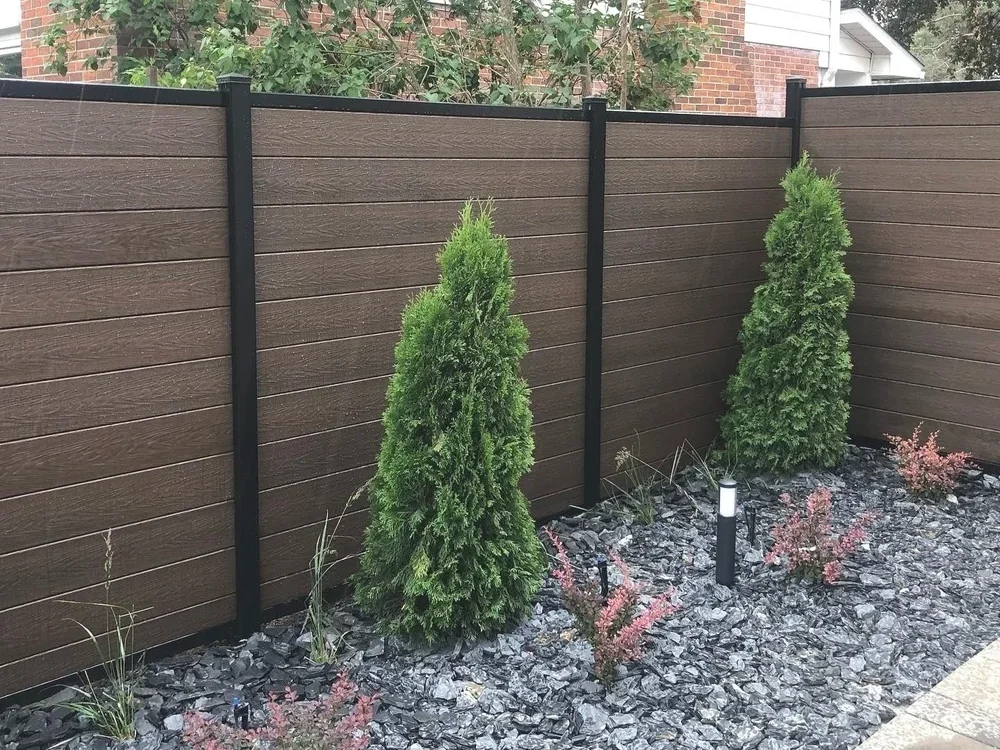 brown-composite-fence-aluminum-posts-cedar-trees